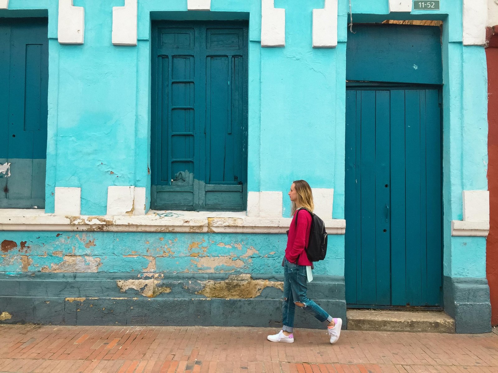 Woman Walking Street With Blue Building