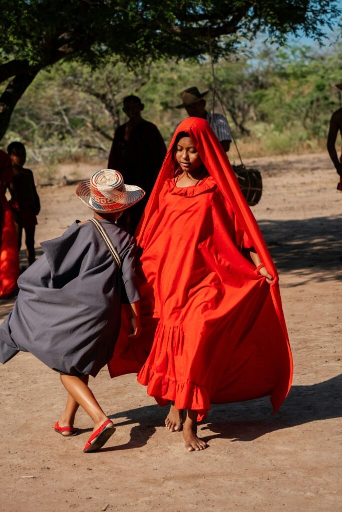 pexels-photo-16041158-16041158 Girl Wearing a Red Dress with a Vail, Dancing Barefoot on the Soil